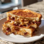 Indulge in the Ultimate Caramelized Onion Bacon Grilled Cheese Sandwich Experience - Featured Image