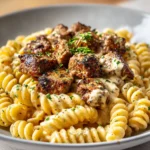 Irresistible Steak Bites Over Cajun-Spiced Alfredo Rotini with a Creamy Parmesan Twist - Featured Image